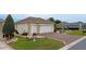 Exterior view featuring a two-car garage, decorative driveway, and manicured landscaping at 11871 Se 91St Cir, Summerfield, FL 34491