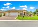 Inviting home showcasing manicured lawn and meticulous landscaping at 11871 Se 91St Cir, Summerfield, FL 34491