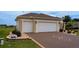 Charming home with a two-car garage, beautiful landscaping, and a well-manicured lawn at 11871 Se 91St Cir, Summerfield, FL 34491