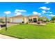 Charming home featuring a well-manicured lawn and attractive landscaping at 11871 Se 91St Cir, Summerfield, FL 34491