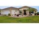 Beautiful home featuring a landscaped front yard with a lush lawn, decorative stones, and colorful potted plants at 11871 Se 91St Cir, Summerfield, FL 34491
