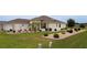 Home exterior boasts lush front lawn, garden beds, mature palm tree, and an inviting facade at 11871 Se 91St Cir, Summerfield, FL 34491