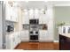 Well-equipped kitchen features white cabinetry, stainless steel appliances, and granite countertops at 11871 Se 91St Cir, Summerfield, FL 34491