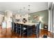 Gourmet kitchen with island, pendant lights, and seamless access to living and dining spaces at 11871 Se 91St Cir, Summerfield, FL 34491