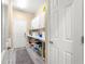Well-organized laundry room with white cabinets and lots of storage at 11871 Se 91St Cir, Summerfield, FL 34491