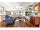 Open living room features hardwood floors and comfortable seating at 11871 Se 91St Cir, Summerfield, FL 34491