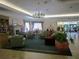 Elegant lobby area with comfortable seating and a grand chandelier at 11871 Se 91St Cir, Summerfield, FL 34491