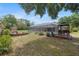 Expansive backyard featuring a screened-in pool, a fire pit with seating, and a grilling area, ideal for outdoor living at 12495 Sw 66Th St, Ocala, FL 34481