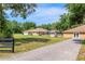 Landscaped backyard featuring lush green grass, a storage shed, and mature trees at 12495 Sw 66Th St, Ocala, FL 34481