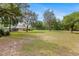Vast backyard with a manicured lawn, scattered trees, and a glimpse of the home at 12495 Sw 66Th St, Ocala, FL 34481