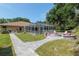 This backyard features a screened-in pool, outdoor fire pit, and comfortable seating for outdoor gathering at 12495 Sw 66Th St, Ocala, FL 34481