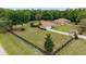 Aerial view of a charming home surrounded by mature trees and a fenced yard at 12495 Sw 66Th St, Ocala, FL 34481