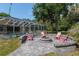 Outdoor fire pit with seating in a backyard setting, adjacent to a screened-in pool, perfect for entertaining at 12495 Sw 66Th St, Ocala, FL 34481
