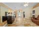 Welcoming home foyer featuring decorative mirror, travertine floors, and bright entrance at 12495 Sw 66Th St, Ocala, FL 34481