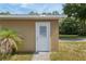 Close-up of a garage side door with stone steps, showcasing an additional access point to the garage or workshop at 12495 Sw 66Th St, Ocala, FL 34481