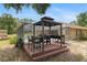 Outdoor grilling station with a canopy, providing a shaded area for barbecues and outdoor dining by the pool at 12495 Sw 66Th St, Ocala, FL 34481
