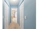 Hallway leading to the bathroom with double closets for storage at 12495 Sw 66Th St, Ocala, FL 34481
