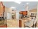Bright kitchen featuring a breakfast bar, stainless steel appliances, and granite countertops at 12495 Sw 66Th St, Ocala, FL 34481