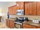 Kitchen with granite countertops, stainless steel appliances, and wood cabinetry at 12495 Sw 66Th St, Ocala, FL 34481