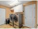 Well-lit laundry room featuring front load washer and dryer, with ample storage and an extra storage closet at 12495 Sw 66Th St, Ocala, FL 34481