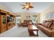 Comfortable living room with large windows offering views of the pool and backyard at 12495 Sw 66Th St, Ocala, FL 34481
