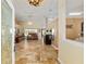 View of the living room showing tile floors, a ceiling fan, and sliding doors to a screened-in lanai at 12495 Sw 66Th St, Ocala, FL 34481