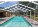 The screened-in pool has a spa, offering a luxurious outdoor experience with plenty of space for swimming at 12495 Sw 66Th St, Ocala, FL 34481