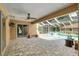 A covered patio overlooking a screened-in pool and spa offers space to relax and entertain outdoors at 12495 Sw 66Th St, Ocala, FL 34481