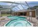 Enjoy the pool and spa area with a screened enclosure, perfect for recreation at 12495 Sw 66Th St, Ocala, FL 34481
