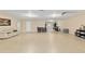 Expansive recreation room featuring neutral walls, epoxy flooring, and versatile layout for games and entertainment at 12495 Sw 66Th St, Ocala, FL 34481