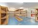 Large storage room with built-in wooden shelving, perfect for organized storage solutions at 12495 Sw 66Th St, Ocala, FL 34481