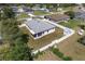 Aerial view of home with grey roof, screened in patio, white fence, and shed at 14055 Sw 30Th Terrace Rd, Ocala, FL 34473