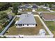 Aerial view of the home with grey roof, white fence and shed in the backyard at 14055 Sw 30Th Terrace Rd, Ocala, FL 34473