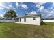 Rear exterior view showcasing the house, lanai, and the spacious fenced backyard at 14055 Sw 30Th Terrace Rd, Ocala, FL 34473