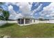 Spacious backyard with white vinyl fencing, screened-in lanai, and lush green grass at 14055 Sw 30Th Terrace Rd, Ocala, FL 34473
