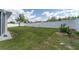 Large backyard with healthy lawn, white privacy fence, and an outbuilding for storage at 14055 Sw 30Th Terrace Rd, Ocala, FL 34473