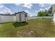 Lush backyard with a white fence and a storage shed at 14055 Sw 30Th Terrace Rd, Ocala, FL 34473