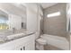 Bathroom featuring a modern vanity with granite countertop, tub, and tiled shower at 14055 Sw 30Th Terrace Rd, Ocala, FL 34473