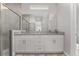 Bathroom showcasing a double vanity with granite countertops and a large mirror at 14055 Sw 30Th Terrace Rd, Ocala, FL 34473