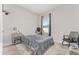 Bedroom featuring a window with curtains, side tables, and a comfortable bed at 14055 Sw 30Th Terrace Rd, Ocala, FL 34473