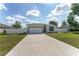 Beautiful single-story home with a spacious driveway, two-car garage, and fenced yard at 14055 Sw 30Th Terrace Rd, Ocala, FL 34473