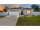 Beautiful home featuring an attached two-car garage, manicured lawn, and inviting entrance at 14055 Sw 30Th Terrace Rd, Ocala, FL 34473