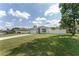Well-maintained home exterior with a green lawn, driveway, and blue and white trim at 14055 Sw 30Th Terrace Rd, Ocala, FL 34473