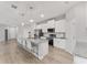 Modern kitchen features stainless appliances, white cabinetry and a large island with seating at 14055 Sw 30Th Terrace Rd, Ocala, FL 34473