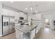 Modern kitchen features stainless appliances, white cabinetry and a large island with seating at 14055 Sw 30Th Terrace Rd, Ocala, FL 34473