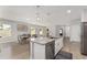 Kitchen with an island and stainless steel appliances, adjacent to a dining area with a large table and chairs at 14055 Sw 30Th Terrace Rd, Ocala, FL 34473