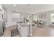 Kitchen island with granite countertops overlooks dining area with large windows and modern decor at 14055 Sw 30Th Terrace Rd, Ocala, FL 34473