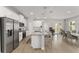 Kitchen boasts a large island with barstool seating open to a dining area with modern furniture at 14055 Sw 30Th Terrace Rd, Ocala, FL 34473