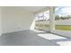 Enclosed lanai showcasing the backyard's green space and fence at 14055 Sw 30Th Terrace Rd, Ocala, FL 34473
