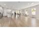 Spacious open-concept living area with light wood flooring, white walls, and modern lighting at 14055 Sw 30Th Terrace Rd, Ocala, FL 34473